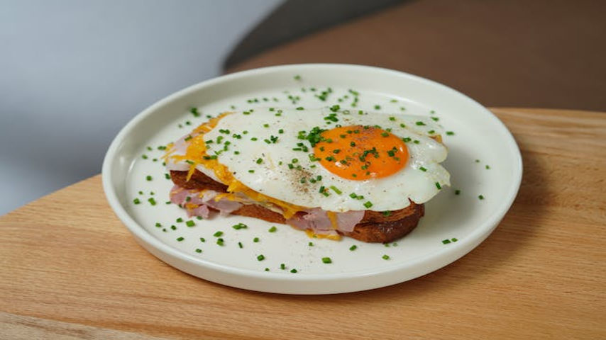 Croque Monsieur https://www.pexels.com/photo/plate-with-croque-madame-sandwich-standing-on-a-wooden-table-18416961/